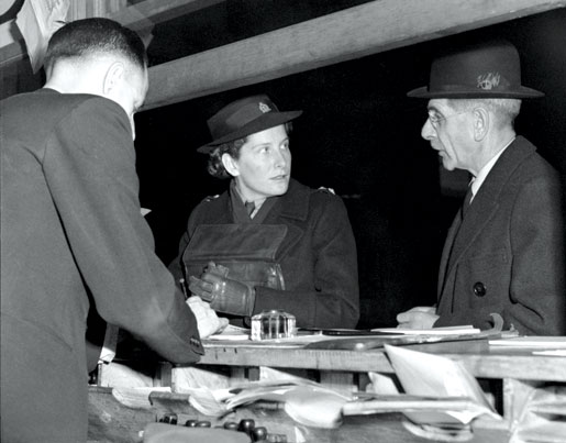 Nursing sister Lieutenant Kay Christie is met by her father in Montreal after returning from Hong Kong, where she and Anna May Waters were the first and only Canadian nursing sisters taken as prisoners of war. [LAC/PA-141659]